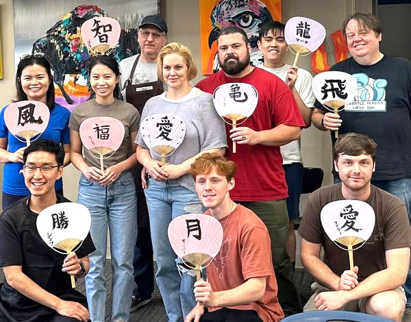 Students show their finished calligraphy projects