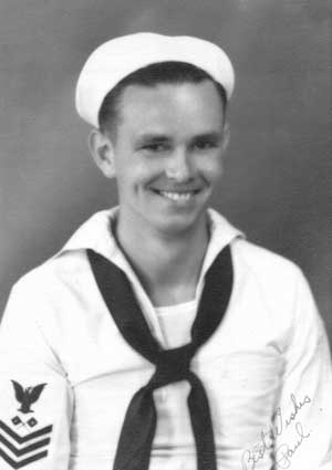 Portrait of a young, smiling Paul Goodyear in a white sailor uniform.