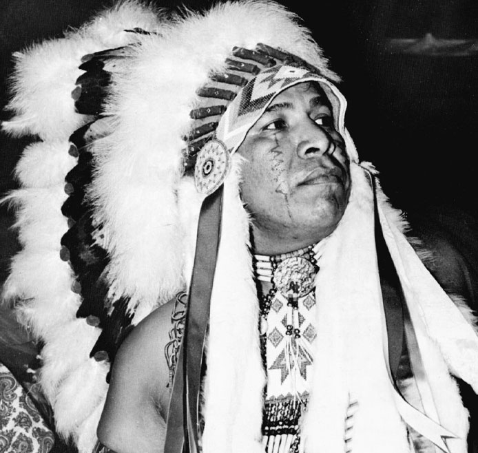 Doc Tate Nevaquaya in a war bonnet 