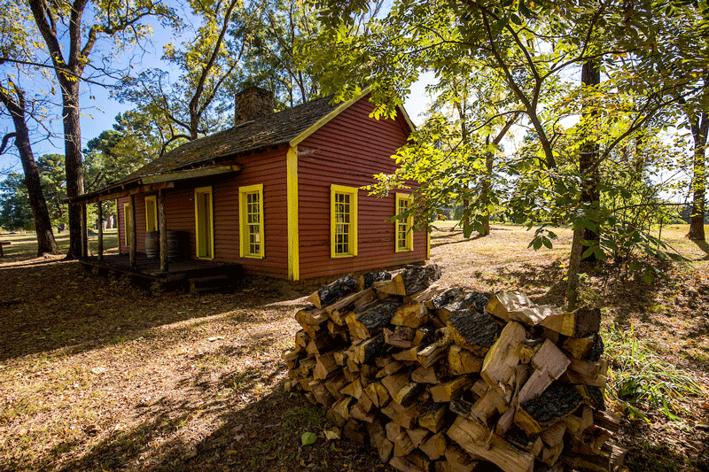 Red sutler's store surrounded by trees at Fort Towson Historic Site